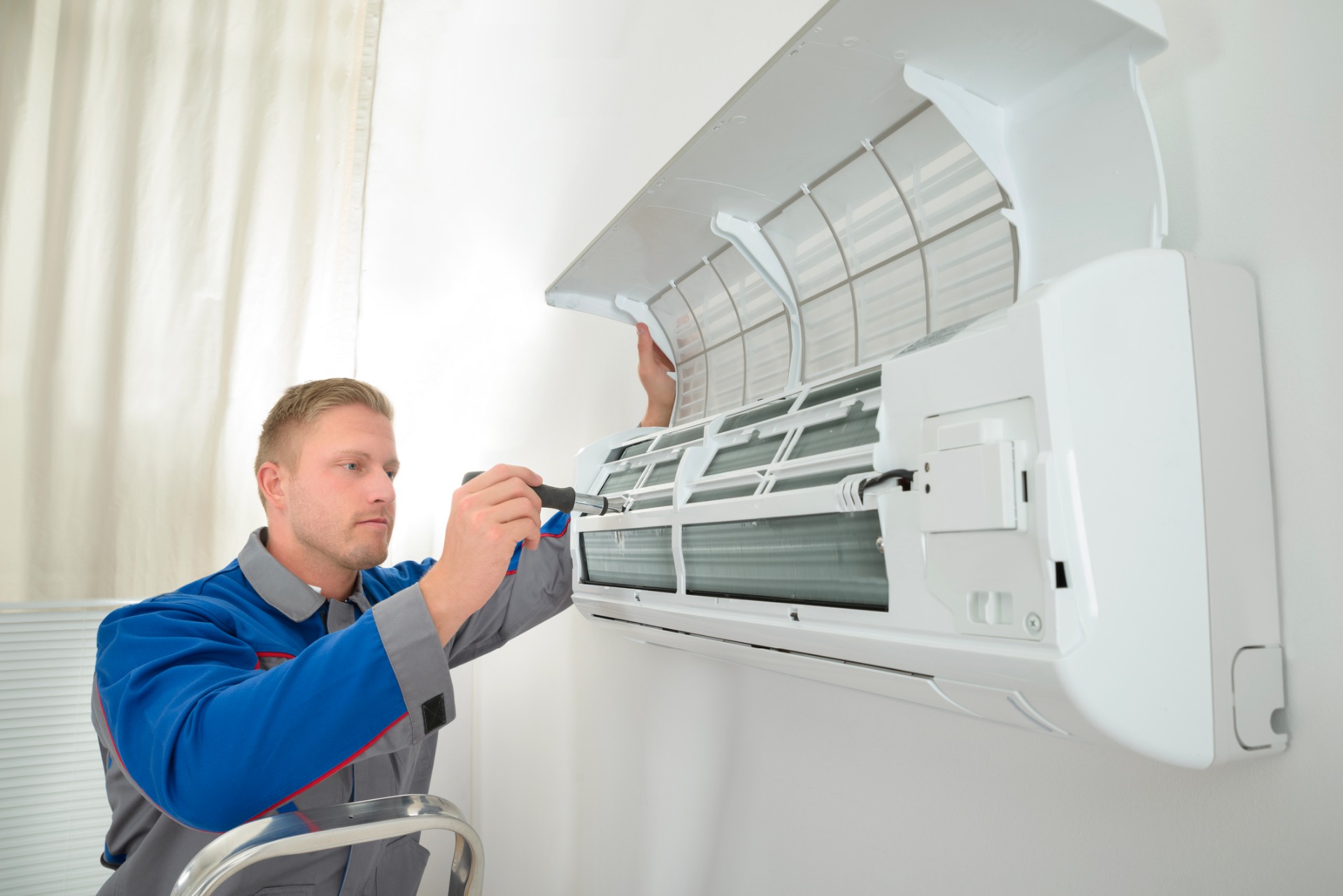 one of our air conditioning maintenance engineers in Hinckley, Leicester, servicing an air conditioning unit